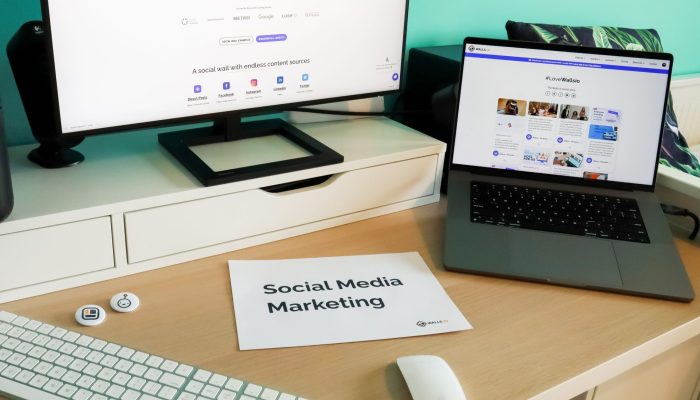 Stylish workspace with laptop and monitor for social media marketing.